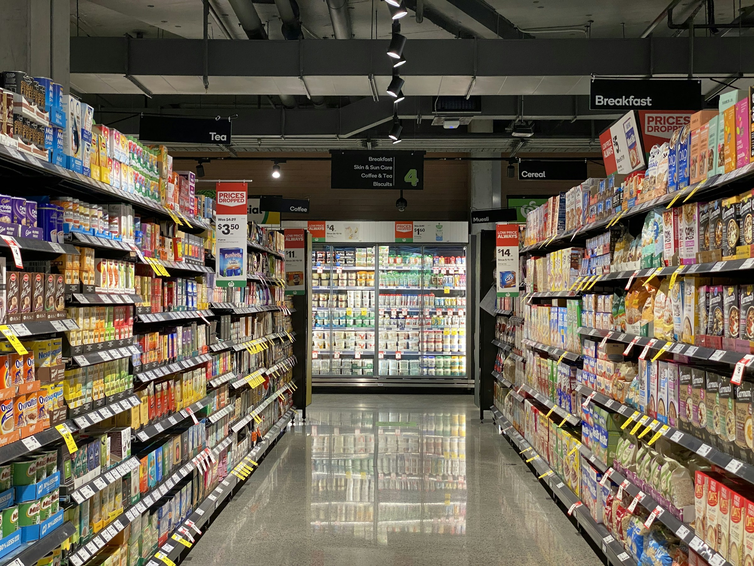Supermarket aisle, stocked shelving either side